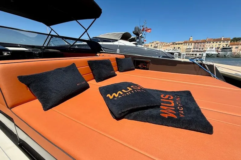 Must Yacht Photos Pics Luxurious 2024 VanDutch 40 yacht with orange seating and branded cushions docked at marina.