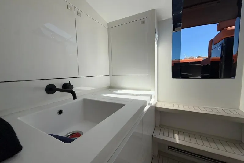 Must Yacht Photos Pics Luxurious interior of 2024 VanDutch 40 yacht featuring sleek white cabinetry and modern sink.