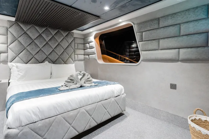  Yacht Photos Pics Luxurious bedroom interior on Custom Yacht 125, featuring elegant bedding and modern design, 2002 model.