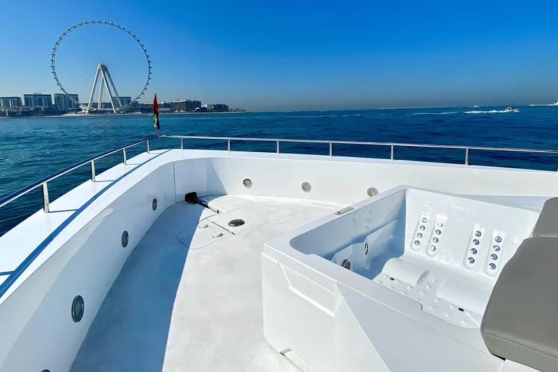  Yacht Photos Pics Luxurious Custom Yacht 125 with jacuzzi, ocean view, and city skyline in the background.
