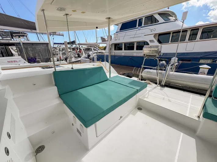 Sunshine Yacht Photos Pics 2017 Lagoon 450 F yacht with teal seating, docked at a marina.