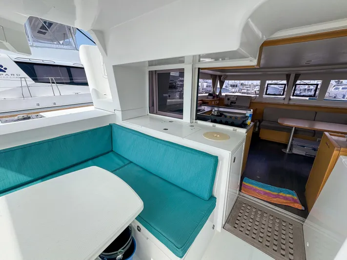 Sunshine Yacht Photos Pics Interior of 2017 Lagoon 450 F catamaran with turquoise seating and modern kitchen area.