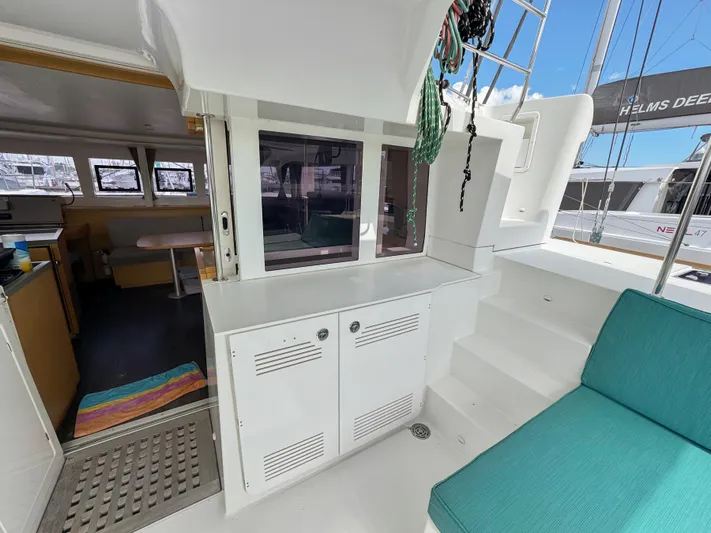 Sunshine Yacht Photos Pics 2017 Lagoon 450 F catamaran interior with seating, storage, and steps leading to deck.