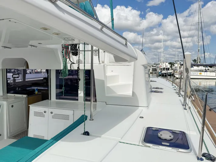 Sunshine Yacht Photos Pics 2017 Lagoon 450 F catamaran deck with marina view, featuring sleek design and clear skies.