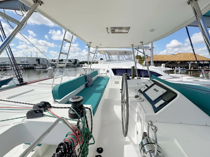 Sunshine Yacht Photos Pics 2017 Lagoon 450 F catamaran with spacious deck, teal seating, and modern navigation equipment.