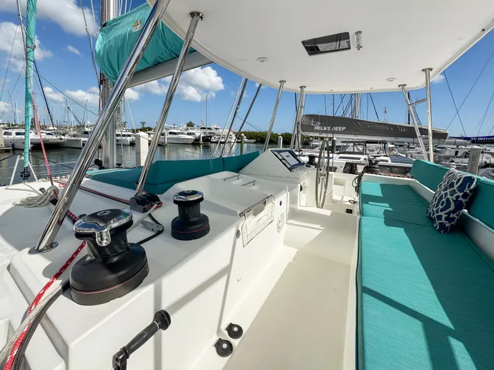 Sunshine Yacht Photos Pics 2017 Lagoon 450 F catamaran interior with turquoise seating, docked at marina.