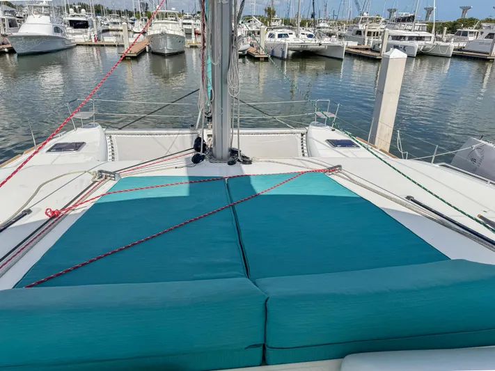 Sunshine Yacht Photos Pics 2017 Lagoon 450 F catamaran with teal cushions docked at a marina.