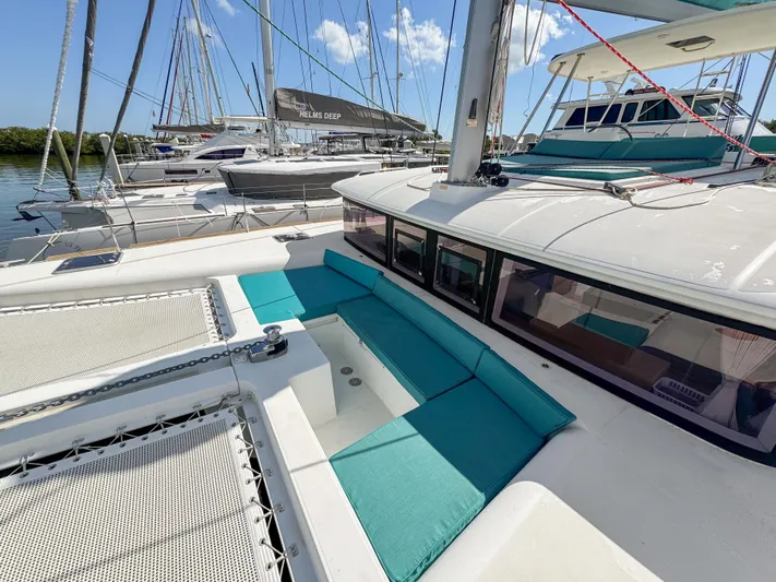 Sunshine Yacht Photos Pics 2017 Lagoon 450 F catamaran with turquoise seating, docked in a marina.