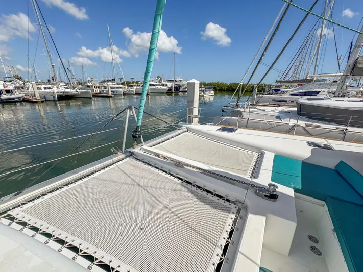 Sunshine Yacht Photos Pics 2017 Lagoon 450 F catamaran docked in a marina under a clear blue sky.