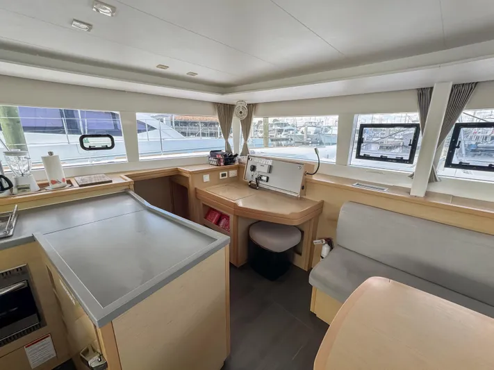 Sunshine Yacht Photos Pics Interior of 2017 Lagoon 450 F catamaran, featuring modern navigation equipment and spacious seating area.