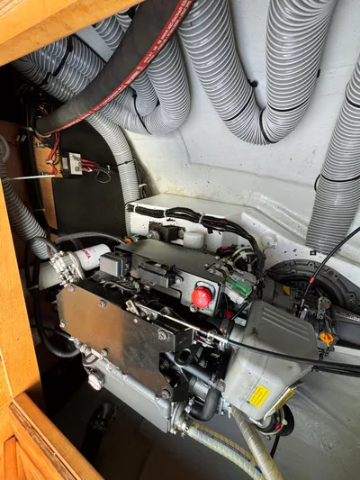 Sunshine Yacht Photos Pics Engine compartment of a 2017 Lagoon 450 F catamaran with visible wiring and hoses.