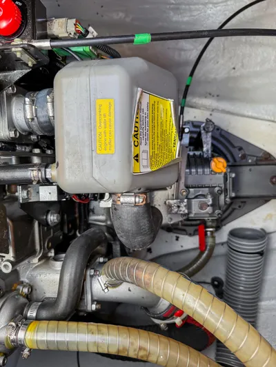 Sunshine Yacht Photos Pics Engine compartment of a 2017 Lagoon 450 F catamaran, showing mechanical components and hoses.