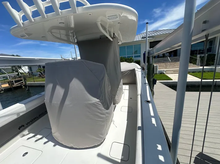  Yacht Photos Pics 2024 World Cat 280ccx boat docked, featuring covered seating and a sleek design.