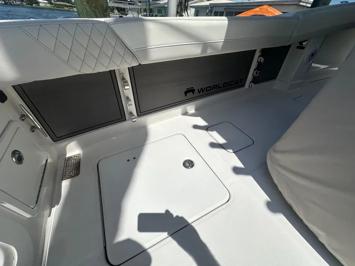  Yacht Photos Pics 2024 World Cat 280ccx boat interior with sleek white seating and storage compartments.