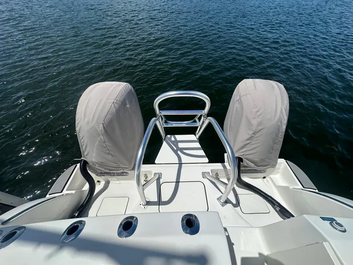  Yacht Photos Pics 2024 World Cat 280ccx boat stern view with covered engines on water.