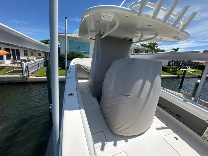  Yacht Photos Pics 2024 World Cat 280ccx boat docked, featuring covered seating and sleek design.