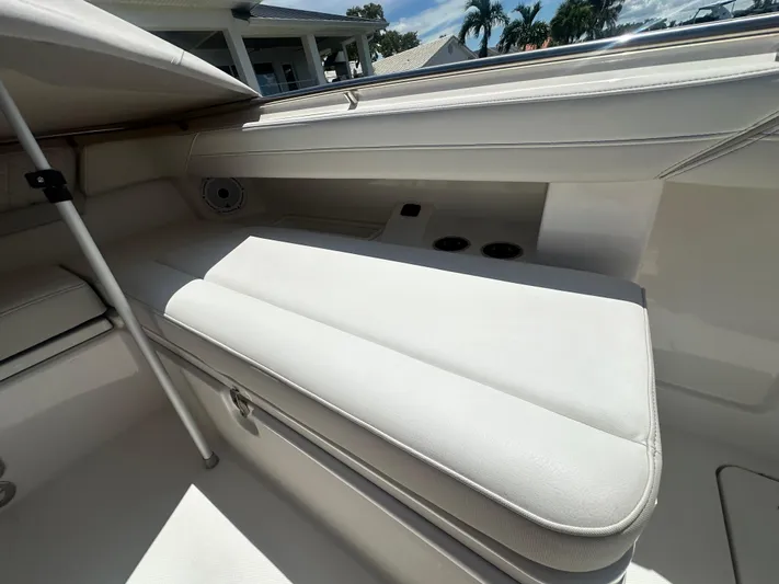 Yacht Photos Pics 2024 World Cat 280ccx boat interior with cushioned seating and cup holders.