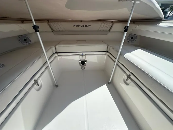  Yacht Photos Pics 2024 World Cat 280ccx boat interior with cushioned seating and storage compartments.