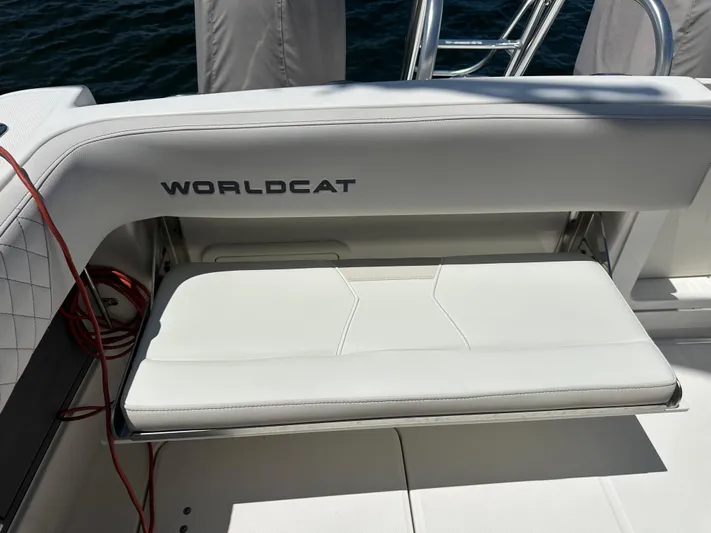  Yacht Photos Pics 2024 World Cat 280ccx boat seat with logo, featuring white upholstery and sleek design.