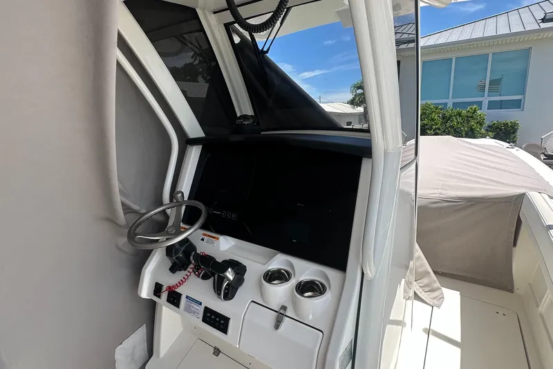  Yacht Photos Pics 2024 World Cat 280ccx boat helm with steering wheel and controls.