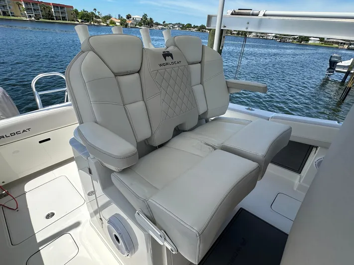  Yacht Photos Pics 2024 World Cat 280ccx boat interior with luxurious seating, overlooking a scenic waterfront.
