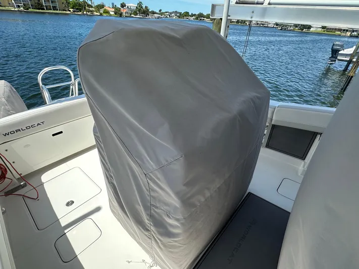  Yacht Photos Pics 2024 World Cat 280ccx boat interior with covered console, docked by the water.