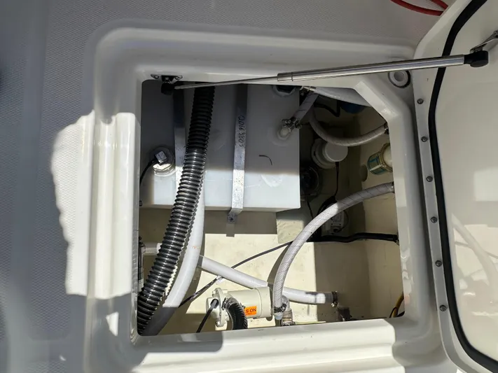  Yacht Photos Pics 2024 World Cat 280ccx boat compartment with visible hoses and mechanical components.