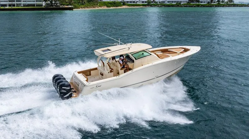  Yacht Photos Pics 2018 Scout 420 LXF boat cruising on water with powerful Mercury engines.