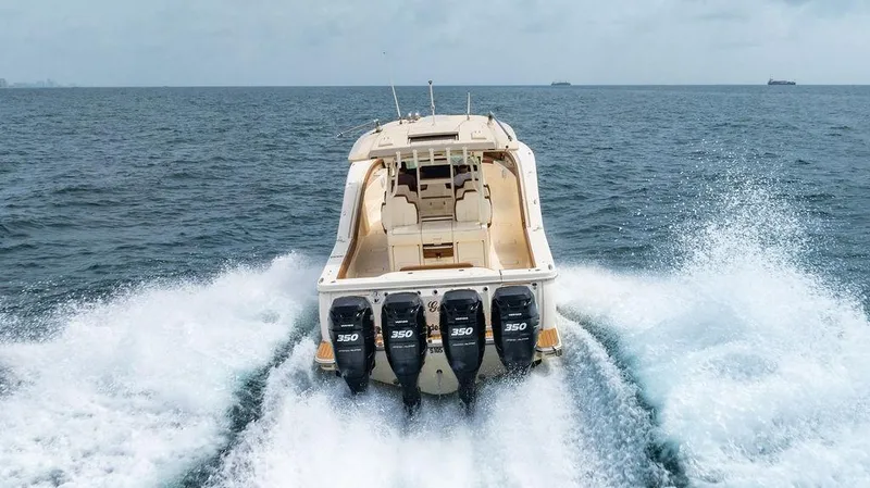  Yacht Photos Pics 2018 Scout 420 LXF boat cruising on open water with four engines.