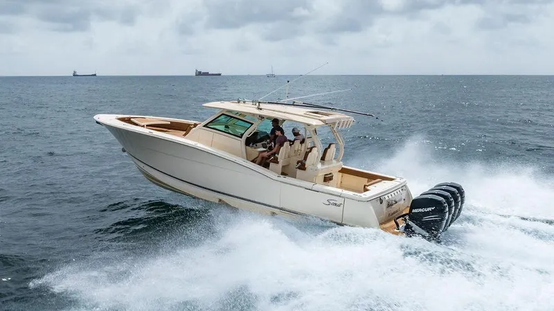  Yacht Photos Pics 2018 Scout 420 LXF boat cruising on open sea with powerful Mercury engines.