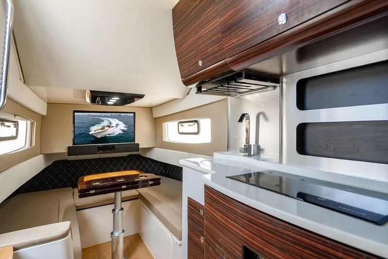  Yacht Photos Pics Luxurious interior of 2018 Scout 420 LXF yacht with modern kitchen and seating area.