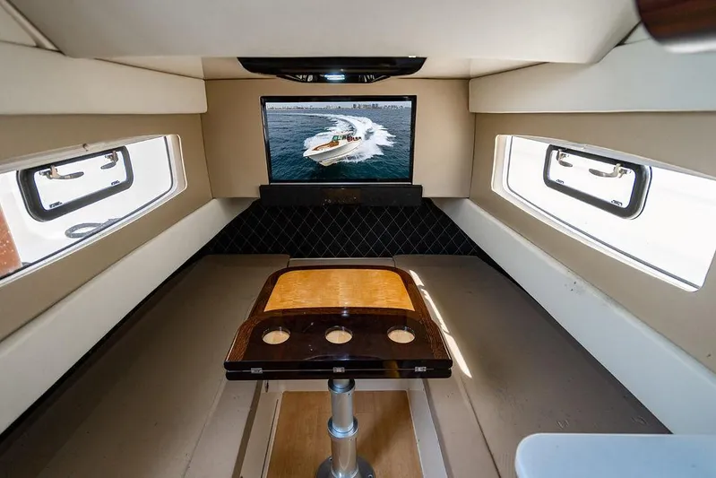  Yacht Photos Pics Interior of 2018 Scout 420 LXF boat with TV and table setup.