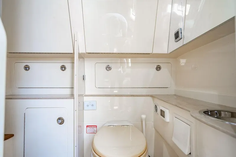  Yacht Photos Pics Luxurious bathroom interior of 2018 Scout 420 LXF boat, featuring sleek cabinetry and modern fixtures.