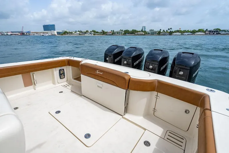  Yacht Photos Pics 2018 Scout 420 LXF boat with multiple outboard engines on a calm waterway.