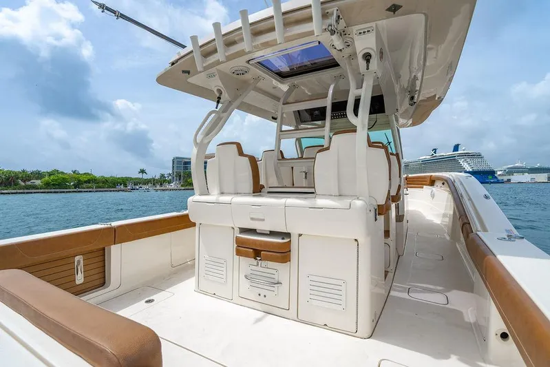  Yacht Photos Pics 2018 Scout 420 LXF boat interior with seating, docked near cruise ships.
