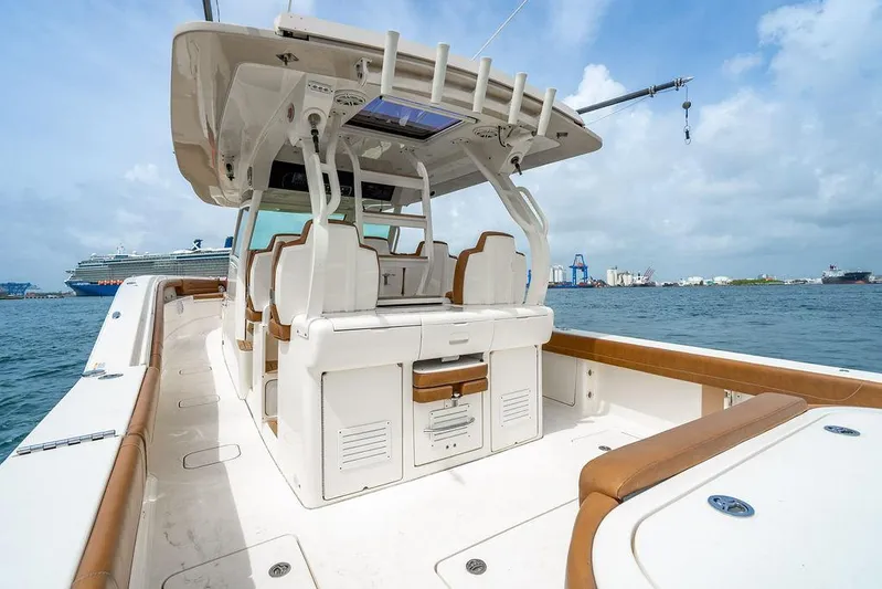  Yacht Photos Pics 2018 Scout 420 LXF boat interior with seating, ocean view, and distant ships.