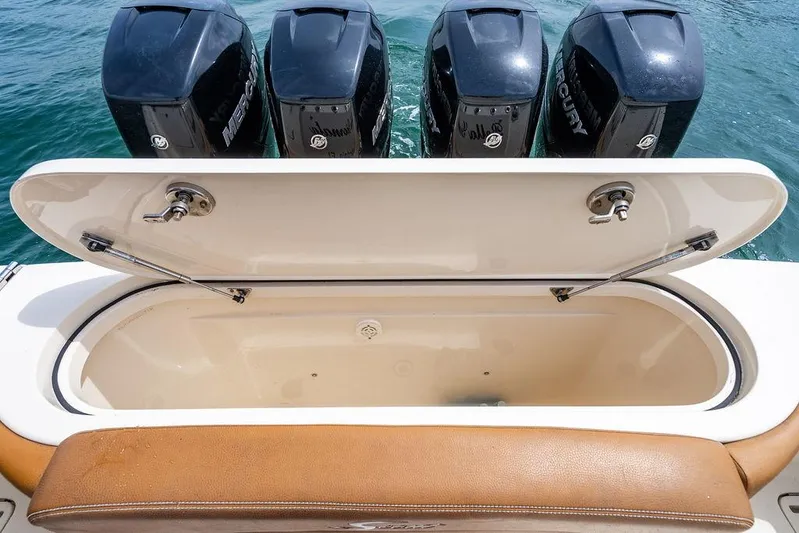  Yacht Photos Pics Open storage compartment on 2018 Scout 420 LXF boat with four Mercury engines.