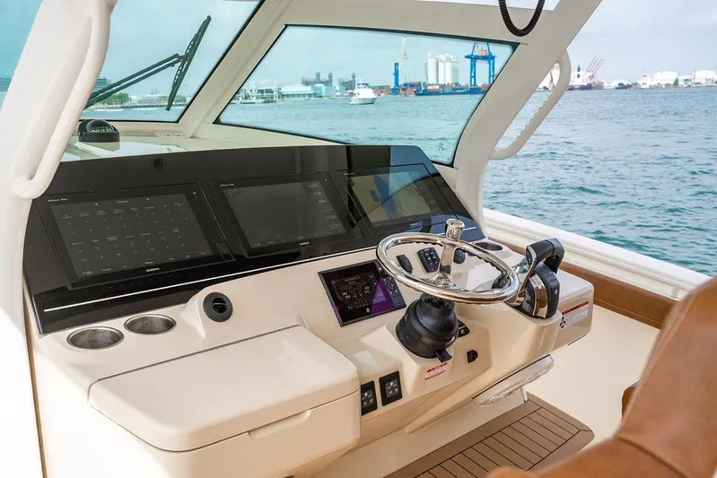  Yacht Photos Pics Helm of 2018 Scout 420 LXF boat with modern navigation displays and steering wheel.
