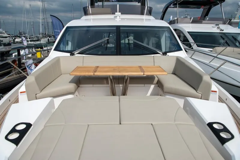  Yacht Photos Pics 2025 Sunseeker Manhattan 68 yacht with luxurious seating and table on deck.