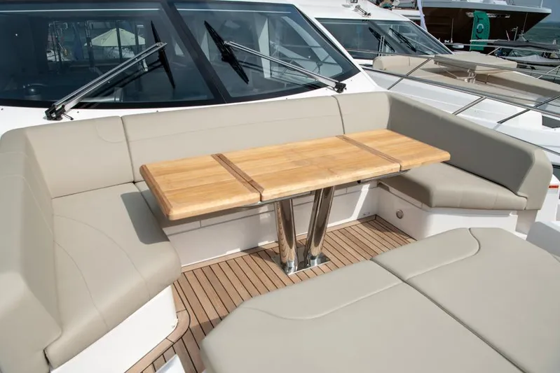  Yacht Photos Pics Luxurious seating area on 2025 Sunseeker Manhattan 68 yacht with wooden table.