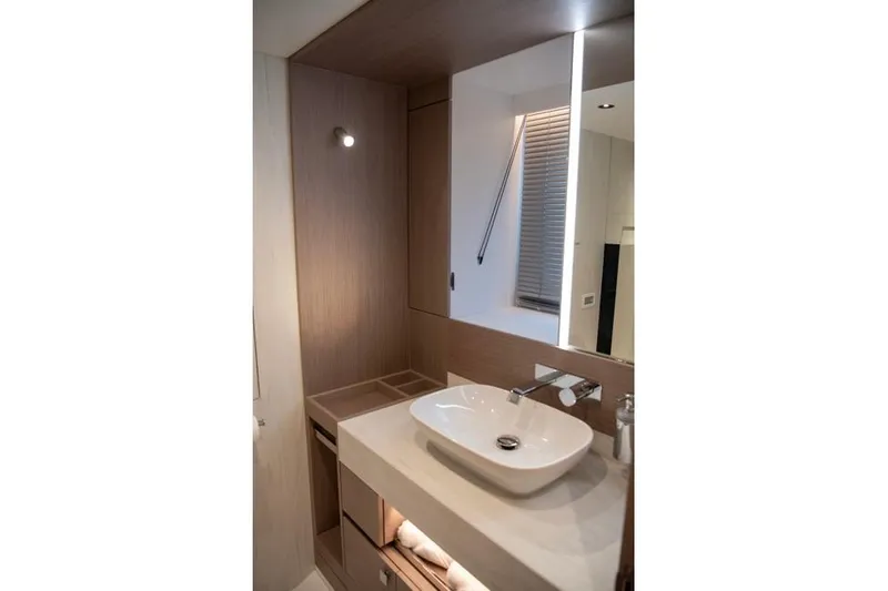  Yacht Photos Pics Modern bathroom interior on 2025 Sunseeker Manhattan 68 yacht, featuring sleek sink and mirror.