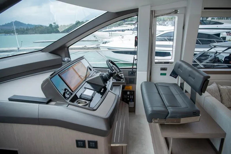  Yacht Photos Pics Luxurious helm of 2025 Sunseeker Manhattan 68 yacht with modern controls and seating.