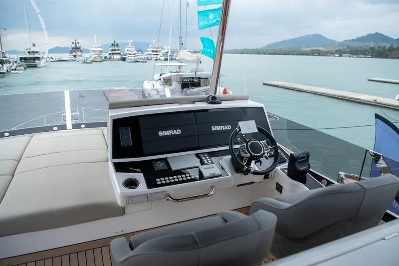  Yacht Photos Pics 2025 Sunseeker Manhattan 68 yacht helm with Simrad navigation, docked in a marina.