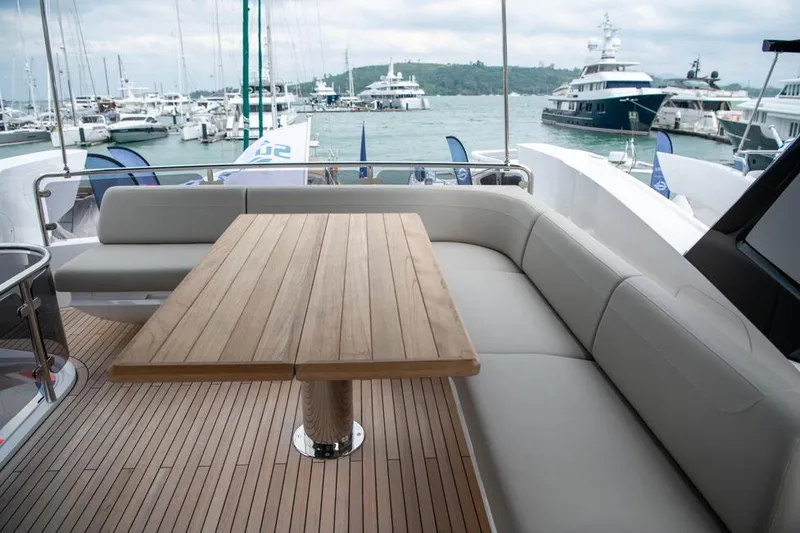  Yacht Photos Pics Luxury Sunseeker Manhattan 68 yacht deck with elegant seating and wooden table, 2025 model.