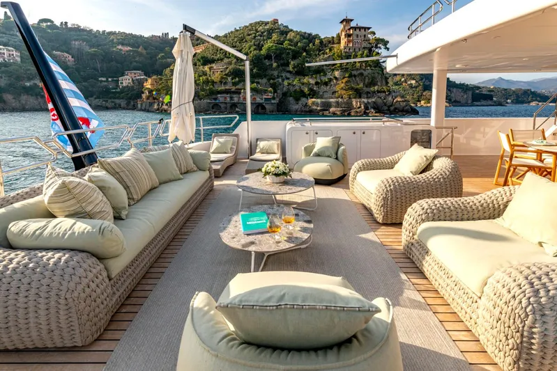 Yacht Photos Pics Luxurious Heesen 38m yacht deck with elegant seating, scenic coastal view, and stylish decor.