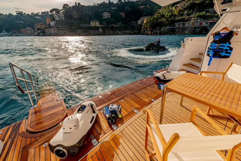  Yacht Photos Pics Luxurious Heesen 38m yacht deck with water sports equipment, scenic coastal view, 2001 model.