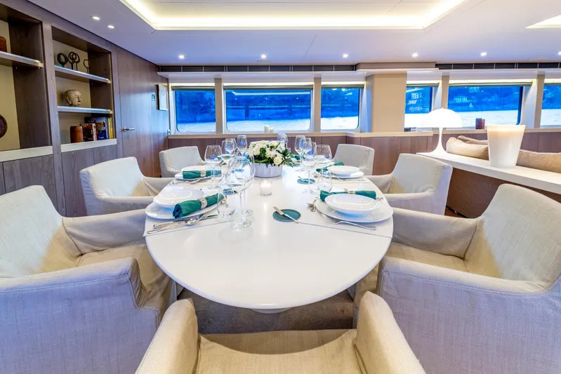  Yacht Photos Pics Luxurious dining area on a 2001 Heesen 38m yacht, elegantly set table, modern decor.