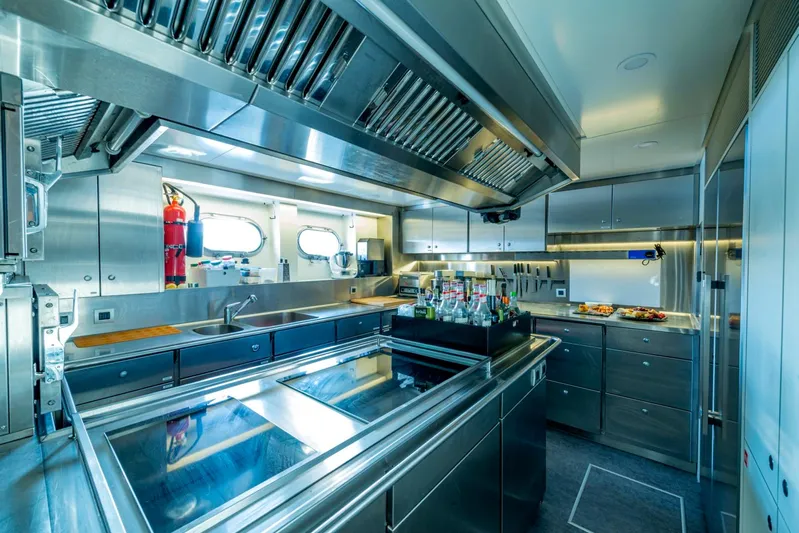  Yacht Photos Pics Modern stainless steel kitchen on a 2001 Heesen 38m yacht, featuring sleek appliances and ample counter space.