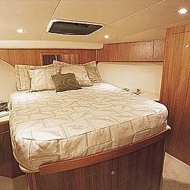 Martin Yacht Photos Pics Luxurious cabin interior of 2002 Luhrs 36 Convertible yacht with cozy bedding.