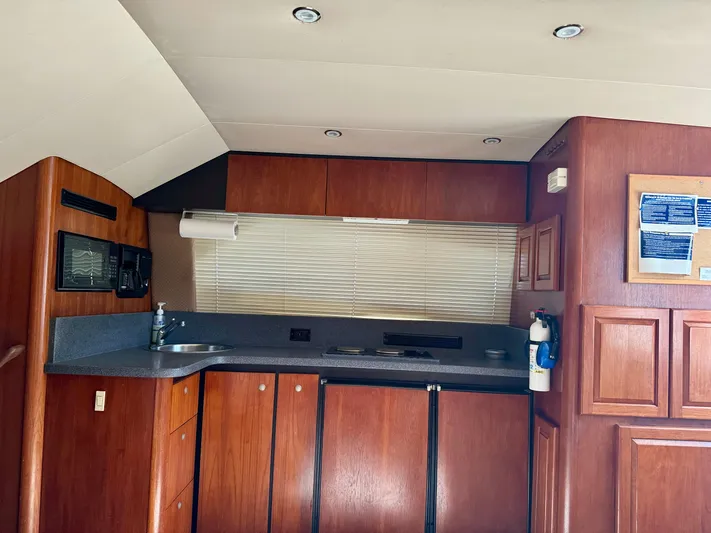 Martin Yacht Photos Pics Interior of 2002 Luhrs 36 Convertible yacht kitchen with wood cabinetry and modern appliances.
